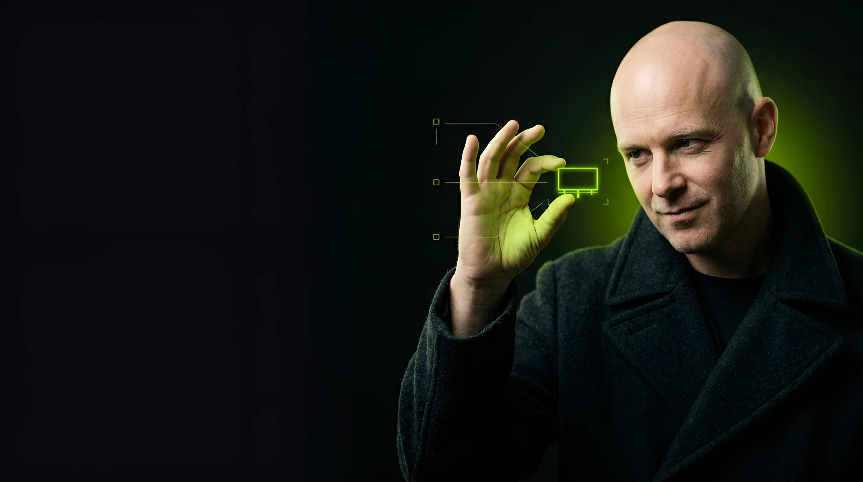 Bald man in a dark overcoat holding a tiny lime billboard frame between thumb and fingers as if measuring it against the dark